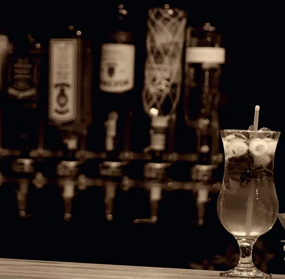 Menu Image Cocktail on a bar counter with bottles in the background